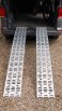 Pair of motorbike loading ramps resting on vehicle boot