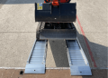 Ramps resting on flat bed vehicle 