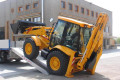 JCB driving up heavy duty loading ramps