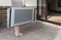 Premium Aerolight Xtra Wheelchair Ramp being carried into a house by the carry handles provided
