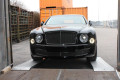 Car driving up car loading ramps