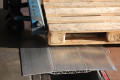 Pallet truck on heavy duty loading bridge