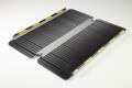 Unfolded wheelchair ramp on ground