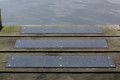 black anti-slip strips on decking by the sea