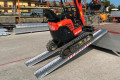 Red tracked machinery going up pair of plant ramps