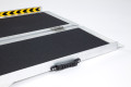 End section of a multi-fold pet ramp on a white background with hazard tape