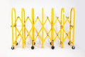 Yellow expandable safety barrier on wheels 