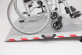 Wheelchair on extra wide folding wheelchair ramp 