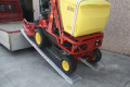 Ride on mower going up plant ramps 