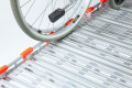 Manual wheelchair prevent rolling off due to safety edges on the access ramp 