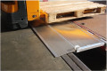 Pallet truck driving over hinged tailboard