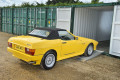Car on loading ramps in to a container