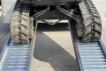 Tracked machine driving on loading ramps