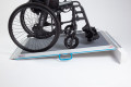 Non-folding wheelchair ramp with self propelled wheelchair going up the ramp