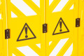Yellow safety barrier with warning signs 