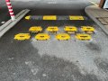 entrance of car park with small flow plates and speed bumps installed to help slow traffic down