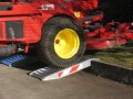 aluminium container ramps resting on kerb 