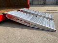 pair of  aluminium container ramps resting on a container 