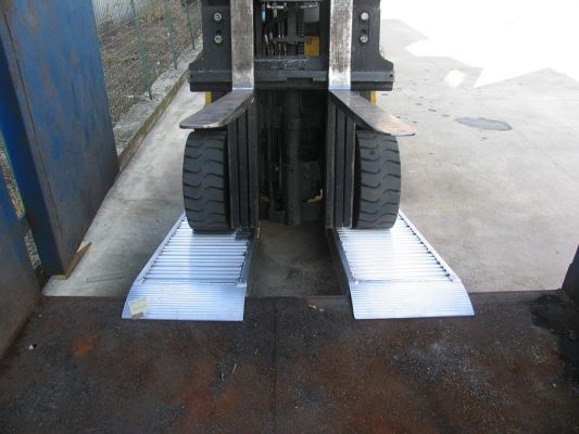 Plant machinery on a Pair of aluminium container ramps