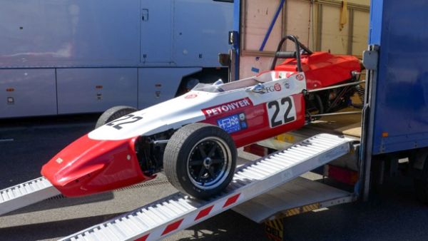 Racing car loading ramps on truck 