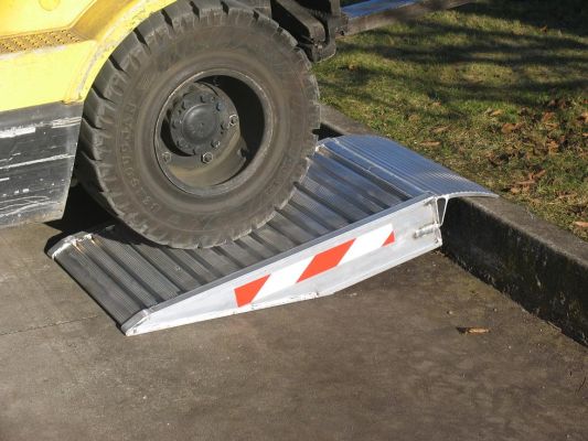 Container ramps resting on kerb 
