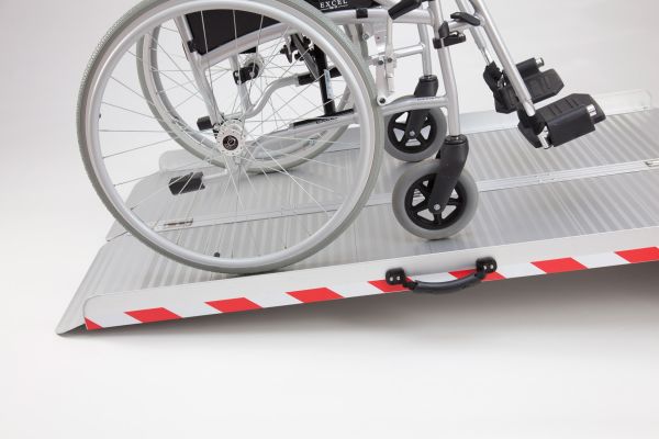 Manual wheelchair on extra wide folding wheelchair ramp