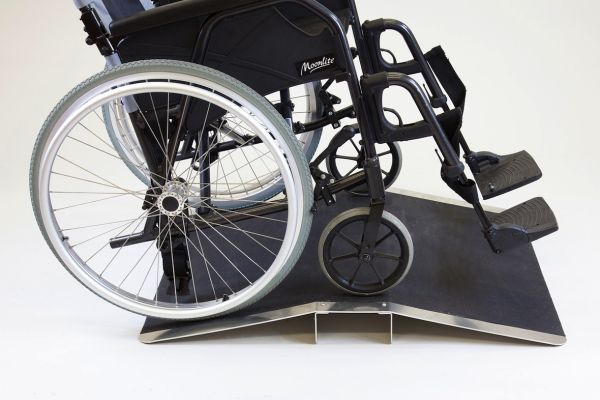 Wheelchair on bridge threshold ramp