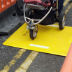 Pushchair passing over a trench cover