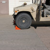 Red wheel chock in front of tyre