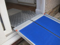 Premium wheelchair ramp resting on threshold ramp 