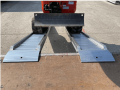 Digger going up loading ramps 