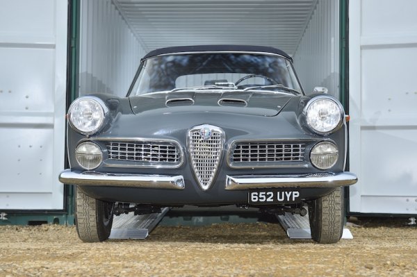 Vintage car on aluminium loading ramps 