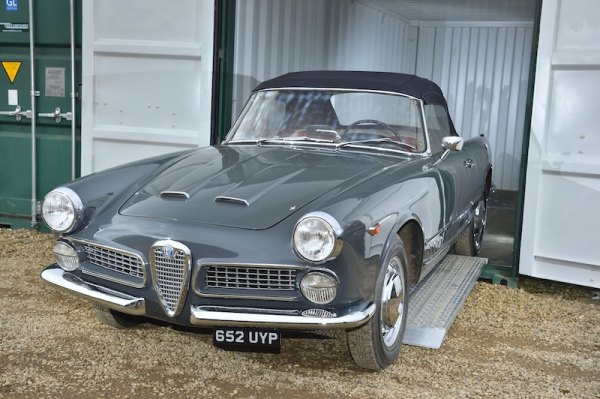 Vintage car unloading from container 