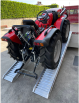 Tractor driving up vehicle ramps onto van 2