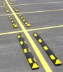 Black and yellow wheel stops marking out parking bays 