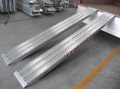 Pair of aluminium ramps resting on vehicle 