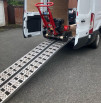 pair of aluminium loading ramps loading machinery into vehicle