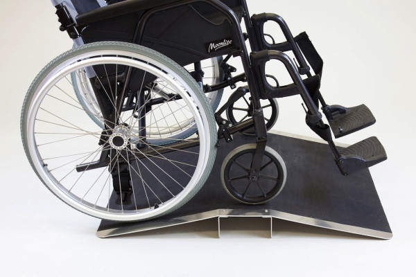 Wheelchair on bridge threshold ramp 