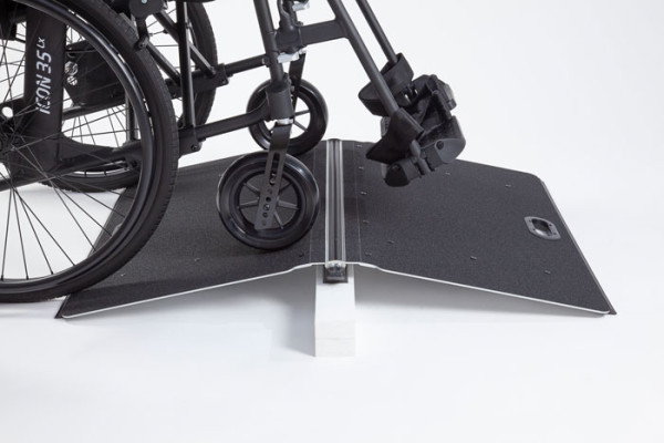 Butterfly ramp with a manual wheelchair going over it