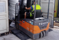 Forklift driving up a rubber container ramp 