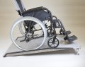Wheelchair on adjustable threshold ramp 