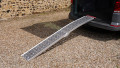 Motorbike loading ramp resting on vehicle boot