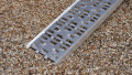 Motorbike loading ramp resting on boot of car, close up of foot end