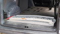 Motorbike loading ramp folded up in boot of car