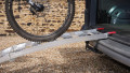 Single aluminium lightweight motorcycle ramp resting on the boot of a vehicle