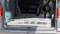 Single aluminium lightweight motorcycle ramp folded up and stored in the boot of a vehicle
