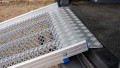 FEAL folding van ramp resting in place on the boot of a car