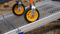 Close up of trolley wheels being pushed up during loading