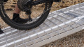 extra wide motorbike loading ramps resting on car with bike being loaded