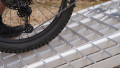 extra wide loading ramps resting on car with bike being loaded